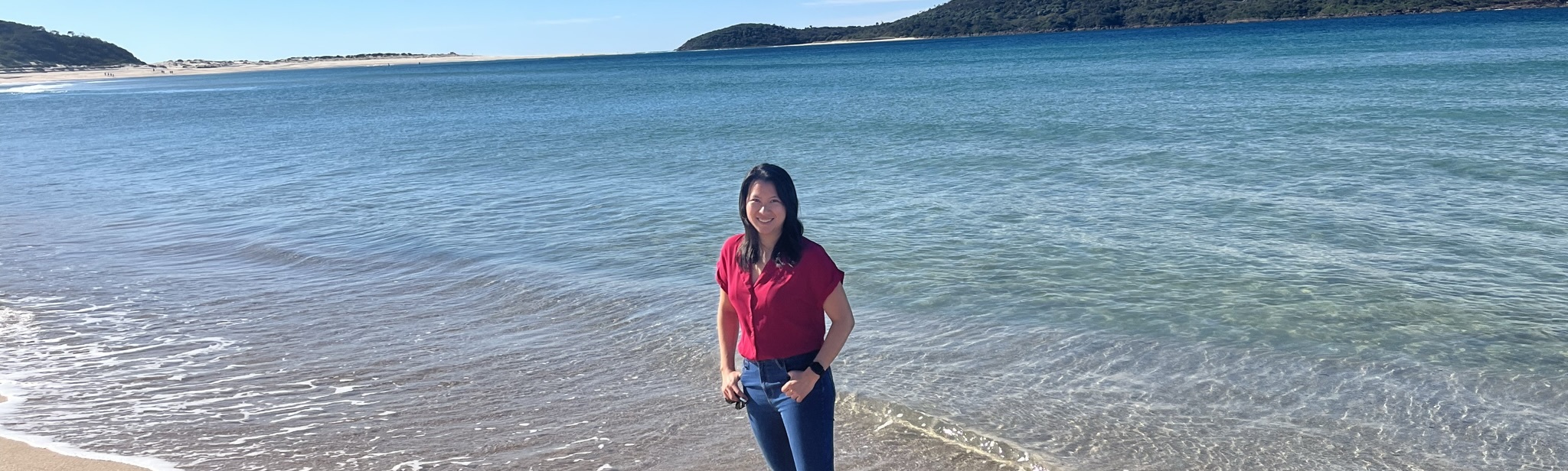 Hana Dinh, product and AI strategist, on a beach in New South Wales, Australia